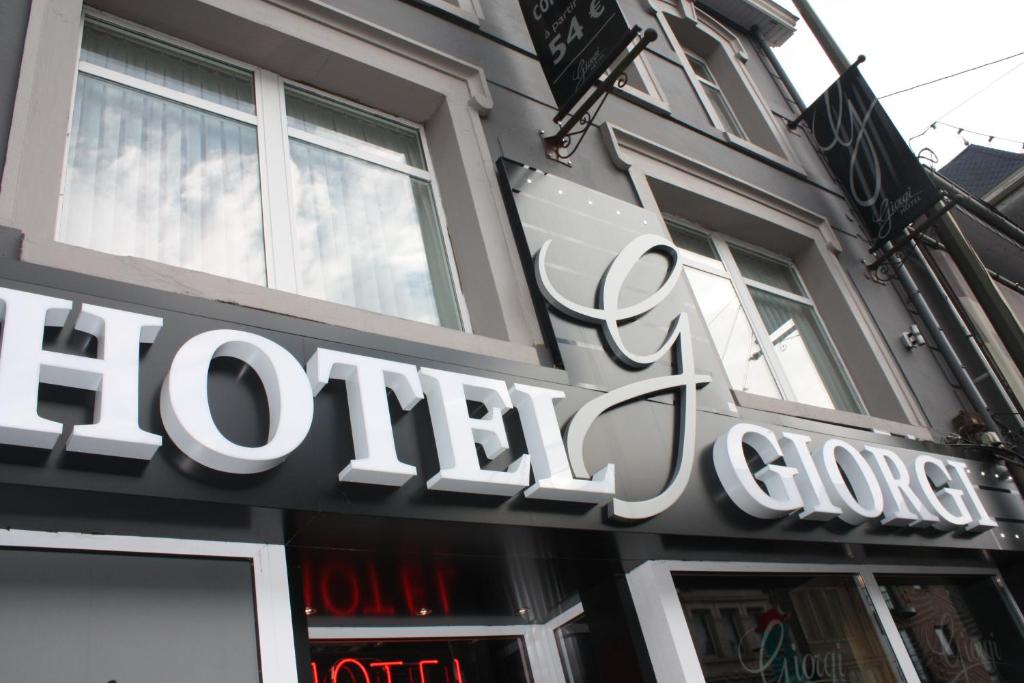 a store sign on the front of a building at Hotel Giorgi in Bastogne