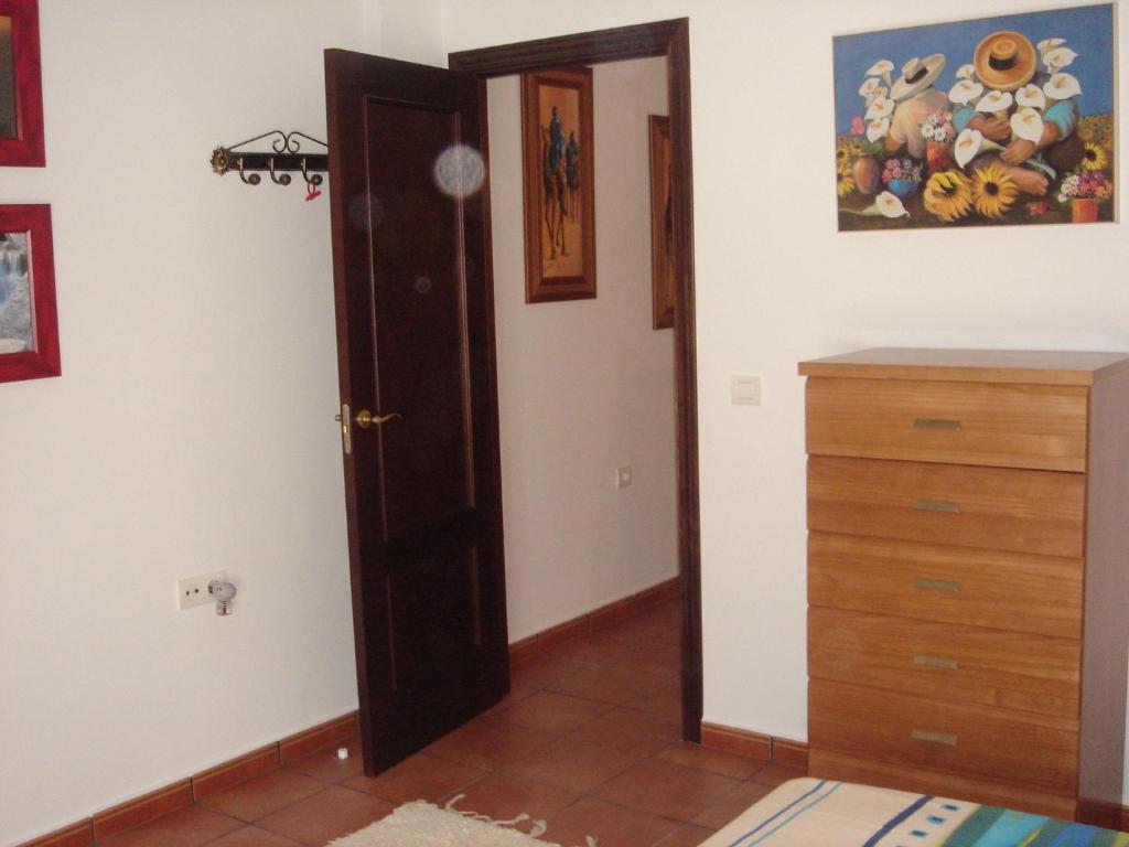 Habitación con puerta y tocador de madera en Ocio Aventura Rural, en Los Romeros