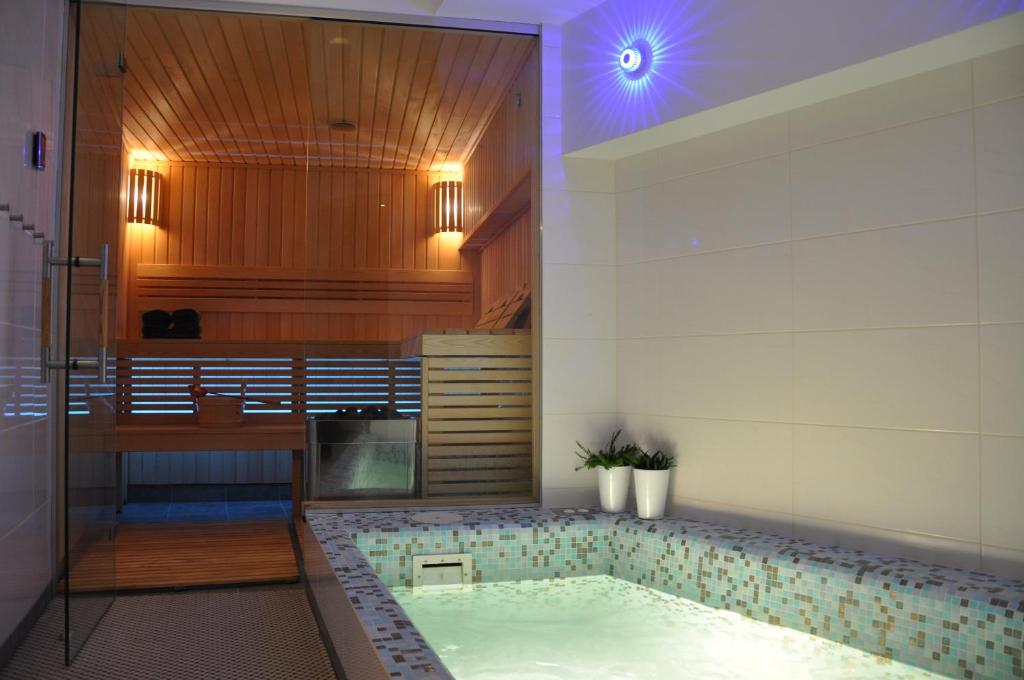 a bathroom with a jacuzzi tub in a room at Bomb Shelter apartment in Vilnius