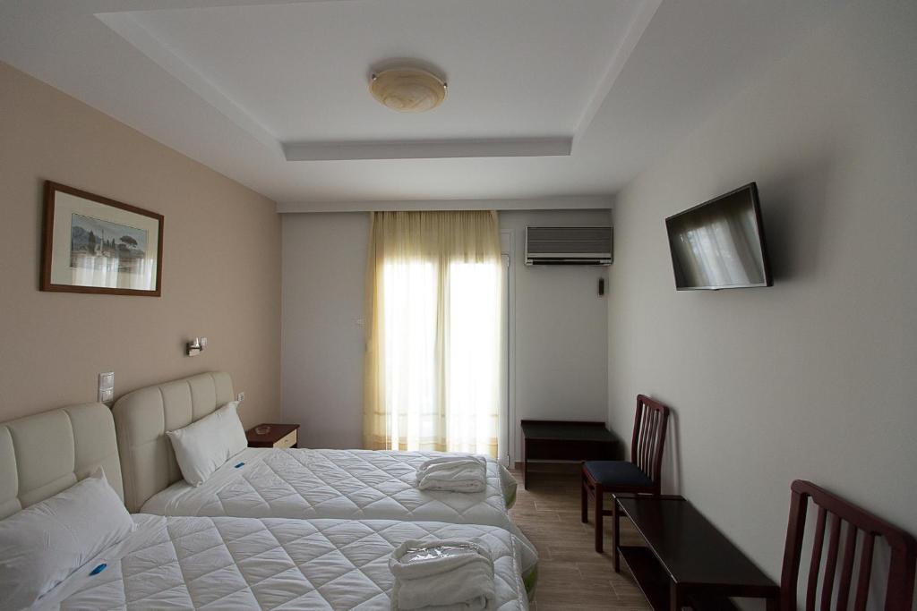 Postel nebo postele na pokoji v ubytování Flisvos Rooms