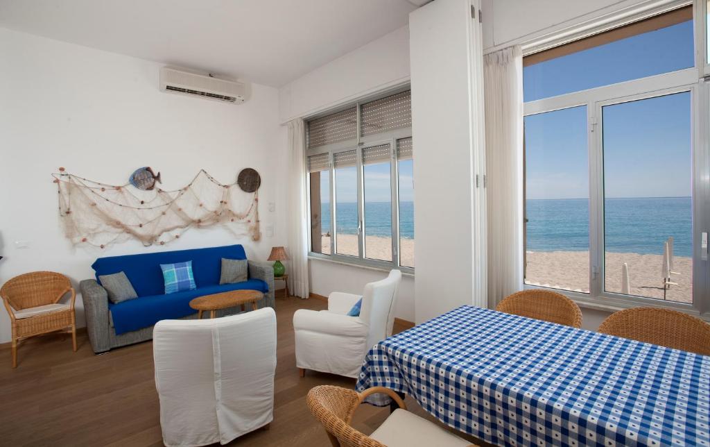 a living room with a bed and a view of the ocean at Residence Le Dune Club in Varigotti