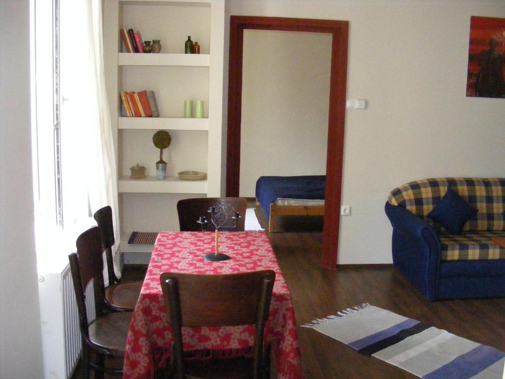 a living room with a table and chairs at Palatinus Apartment in Budapest