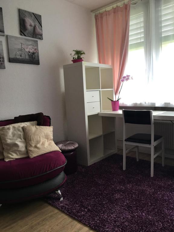 a living room with a desk and a couch and a desk andacistacistacist at Apartments in Bern - Breitenrainplatz in Bern