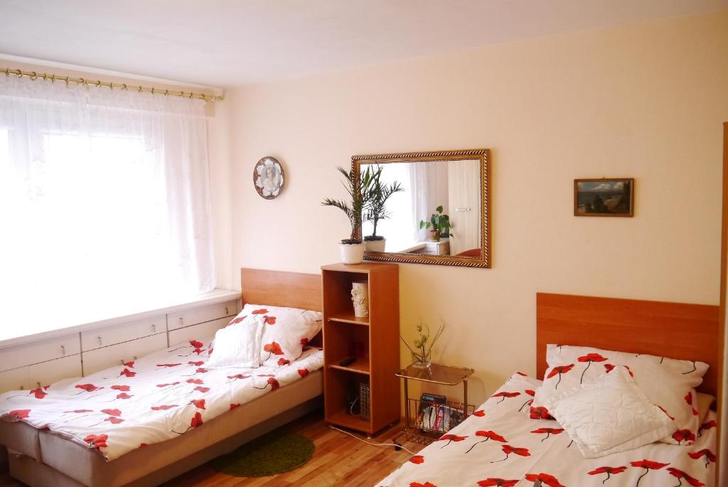 a bedroom with a bed and a mirror at Mieszkanie w Centrum in Gdynia
