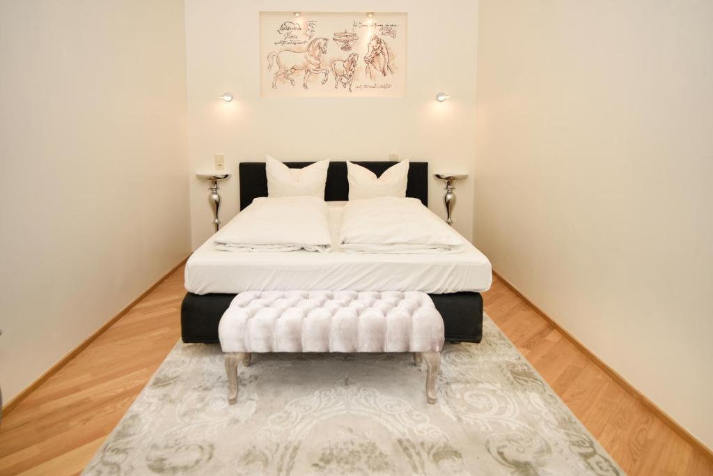 a small bedroom with a bed with a white bedspread at Apartment am Kurpark in Baden-Baden