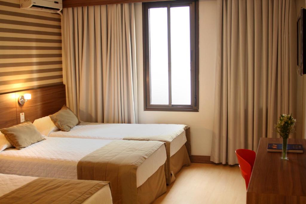 Postel nebo postele na pokoji v ubytování Hotel Continental Business - 200 metros do Complexo Hospitalar Santa Casa