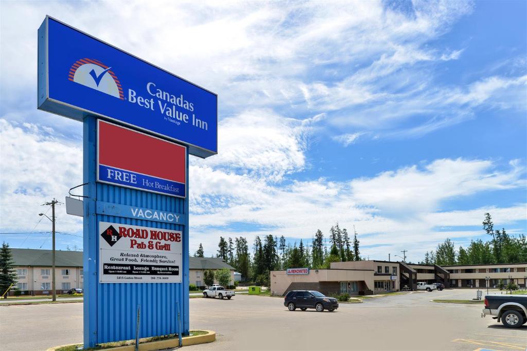 a sign for a best value inn in a parking lot at Canadas Best Value Inn Whitecourt in Whitecourt