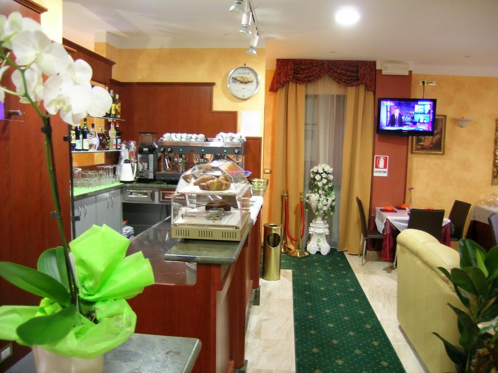 a kitchen with a counter and a dining room at Hotel Air Palace Lingotto in Turin