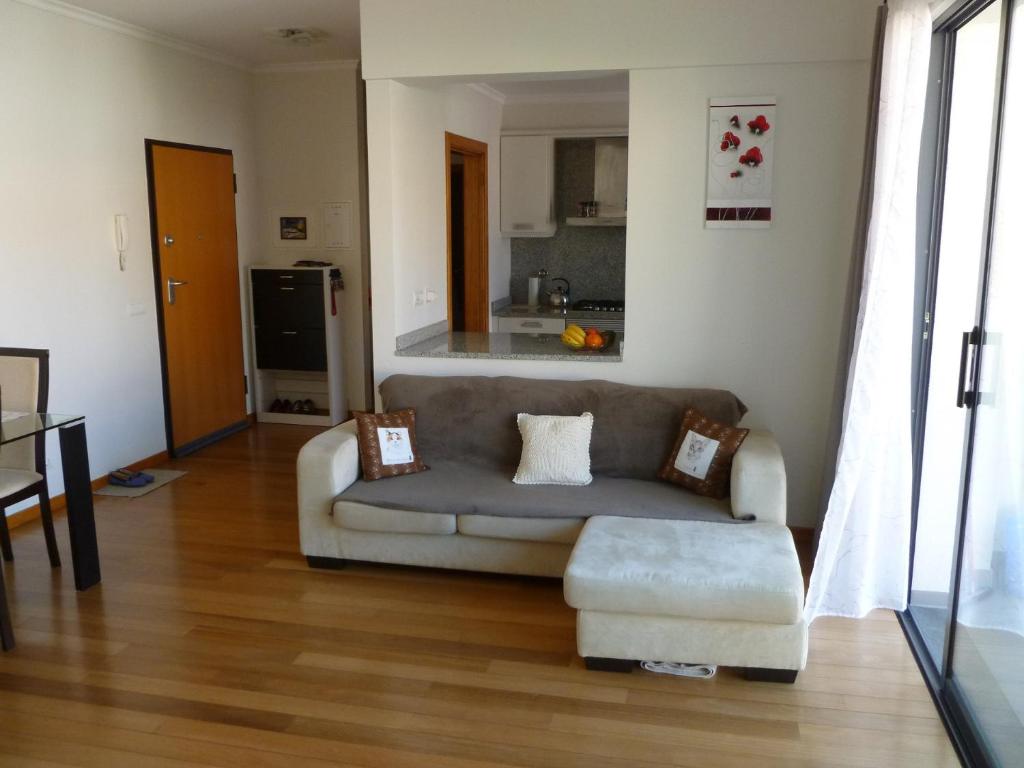 a living room with a couch and a kitchen at Apartment Machico near the beach in Machico