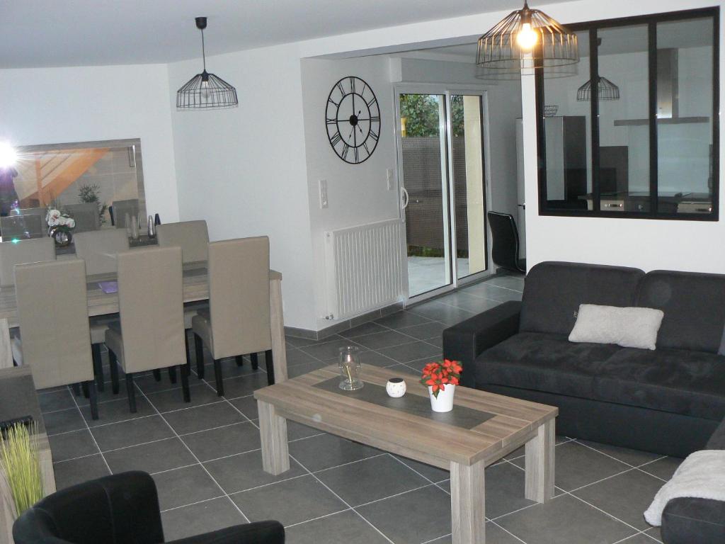 uma sala de estar com um sofá e uma mesa em Cocooning Villa em Cherbourg en Cotentin