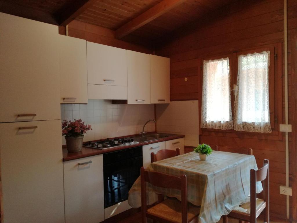 eine Küche mit einem Tisch und einem Herd Top-Backofen in der Unterkunft Campeggio Italia in Marina di Massa