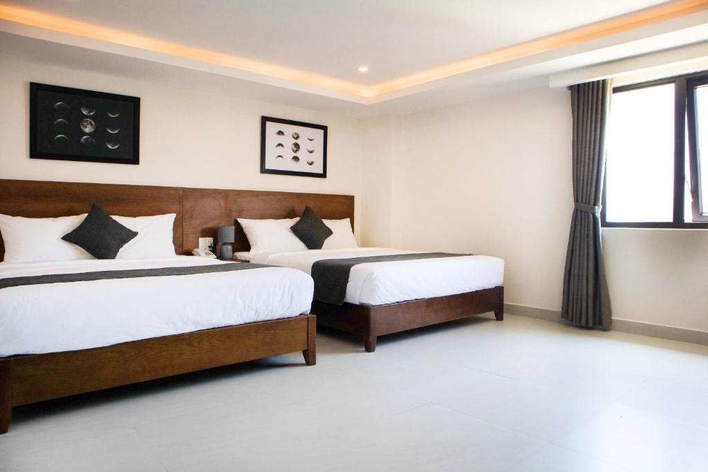 Postel nebo postele na pokoji v ubytování Robin Hotel Danang
