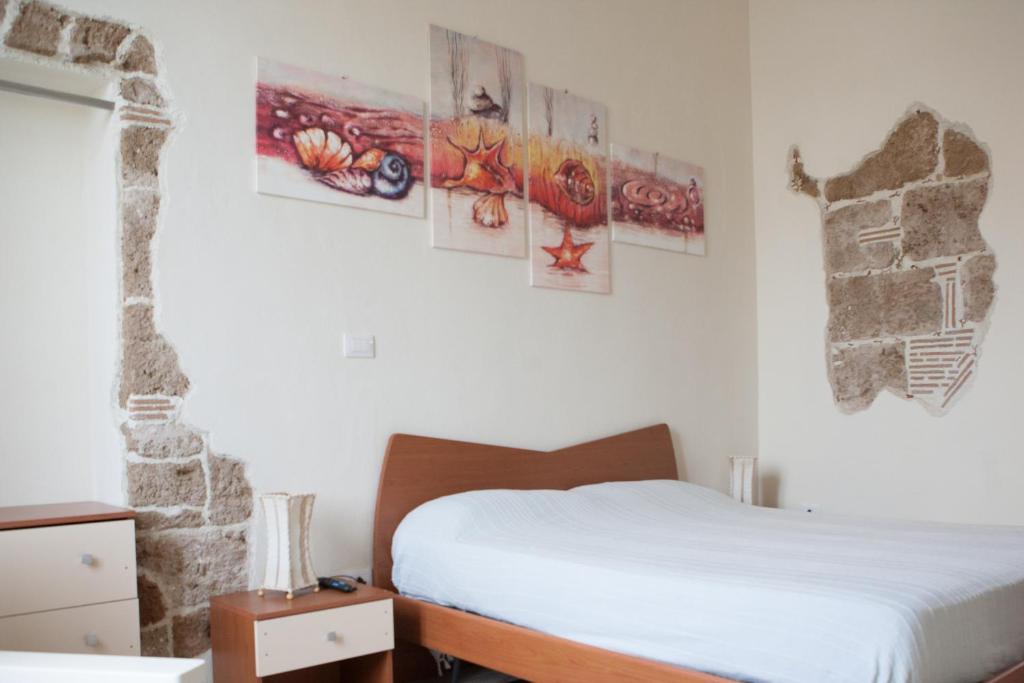 Postel nebo postele na pokoji v ubytování Poseidon Alghero