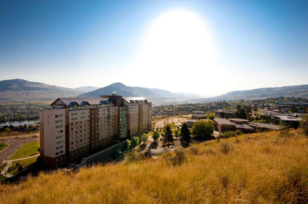 a view of a city with mountains in the background at Residence & Conference Centre - Kamloops in Kamloops