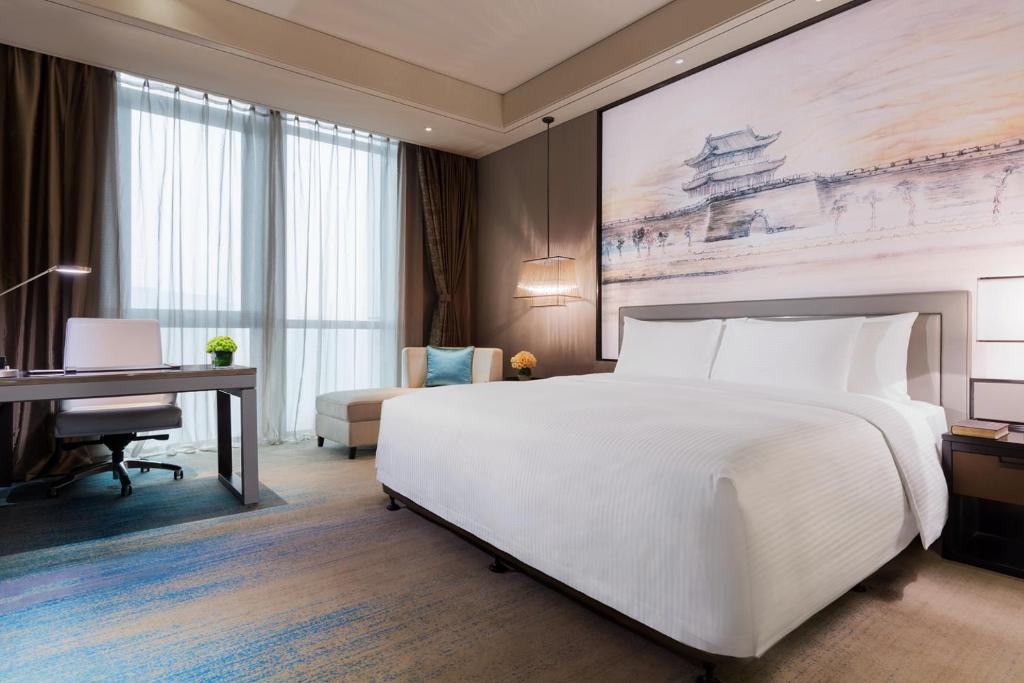 Postel nebo postele na pokoji v ubytování Wanda Realm Jingzhou