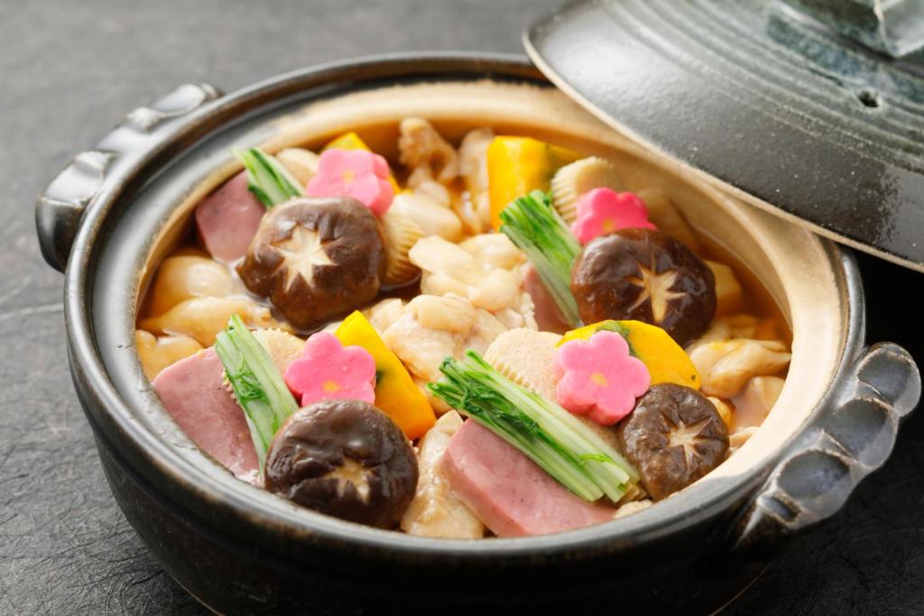 a bowl of soup with meat and vegetables in it at HOTEL MYSTAYS Kanazawa Castle in Kanazawa