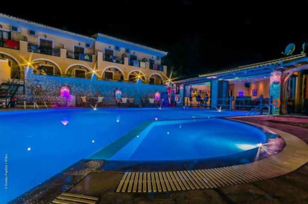 a large swimming pool at a hotel at night at Villa Birlis in Liapades