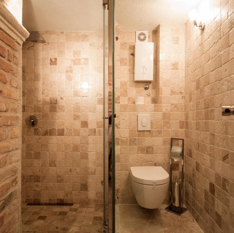 a bathroom with a toilet and a shower at Hotel Azimut in Sveti Stefan