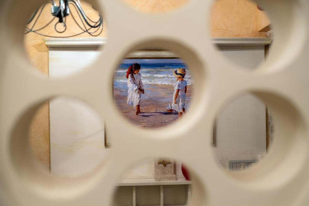 a reflection of two girls on the beach in a mirror at Hotel Azimut in Sveti Stefan