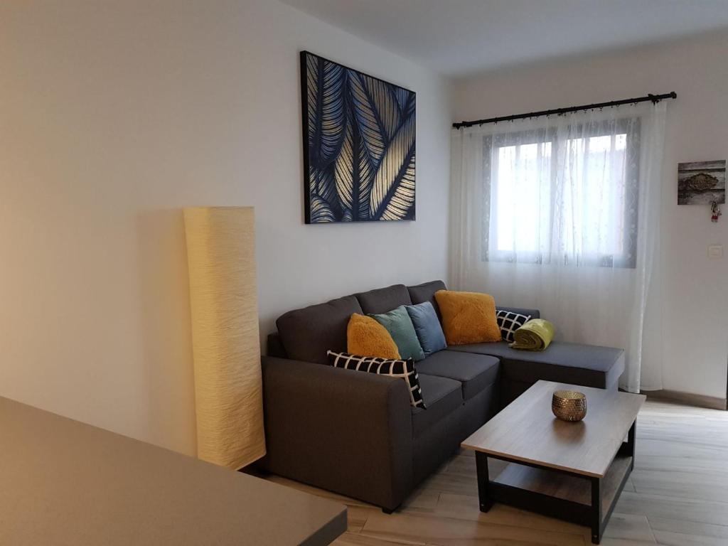 a living room with a couch and a table at La Vega de Mary in Arrecife