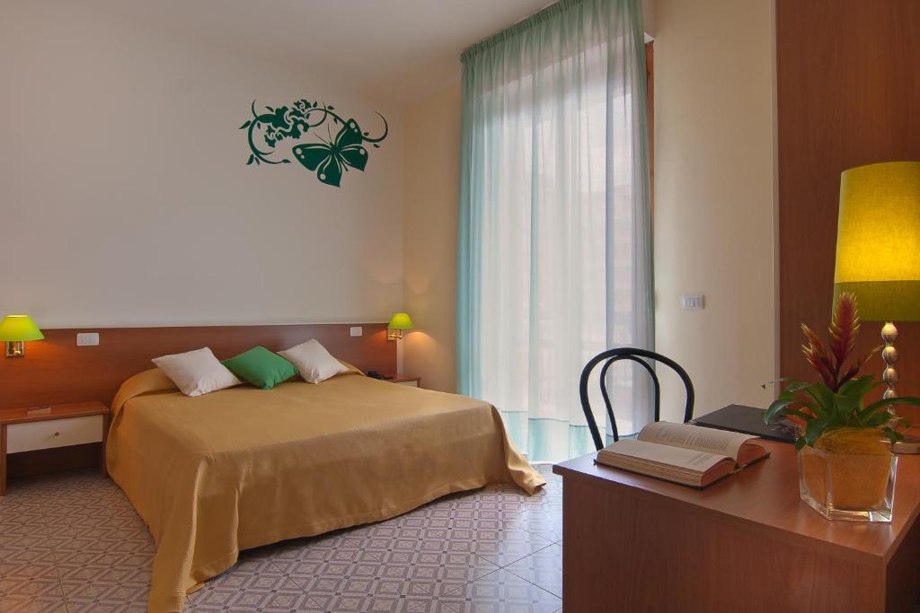 Postel nebo postele na pokoji v ubytování Mio Hotel Firenze