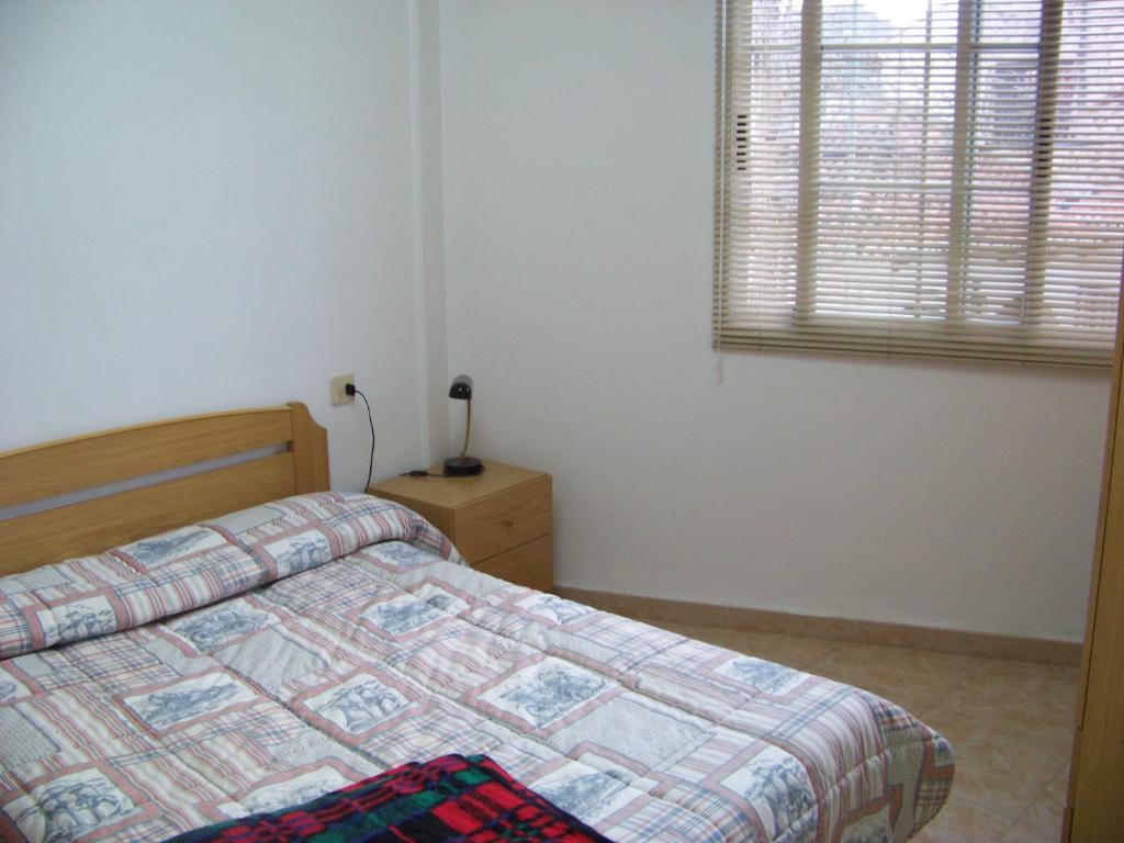A bed or beds in a room at Apartamentos Chelo