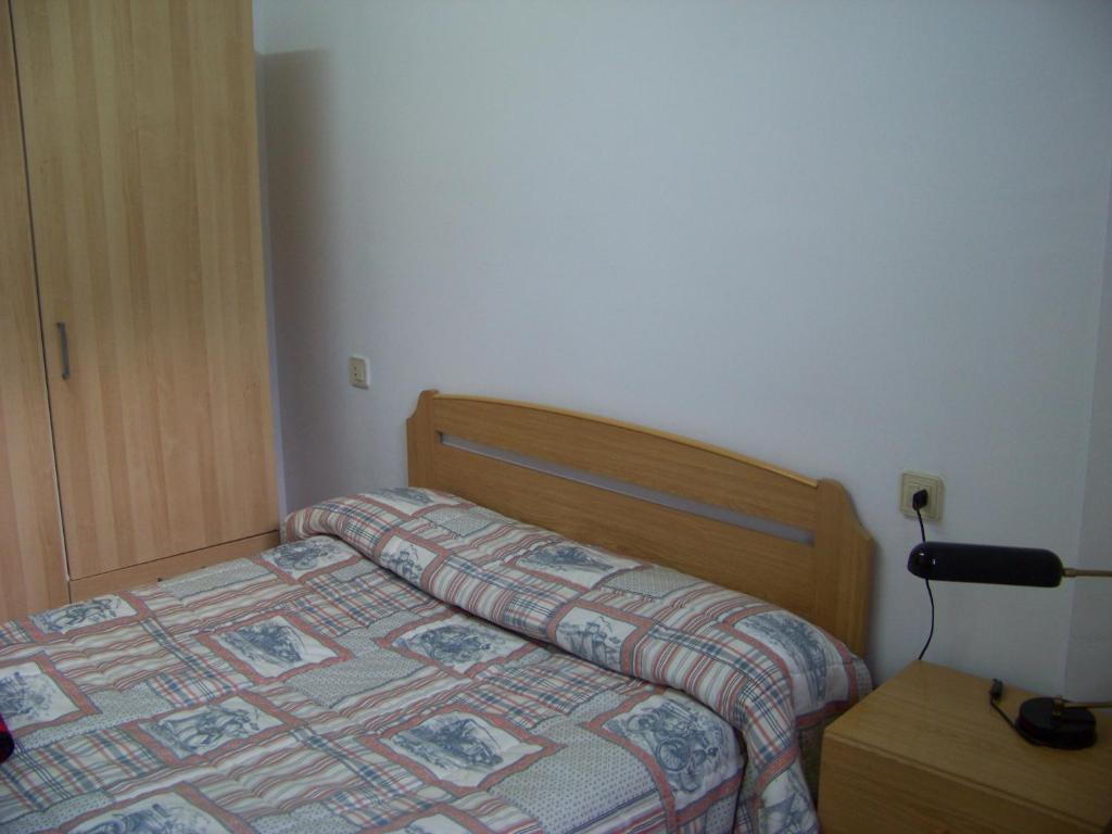 A bed or beds in a room at Apartamentos Chelo