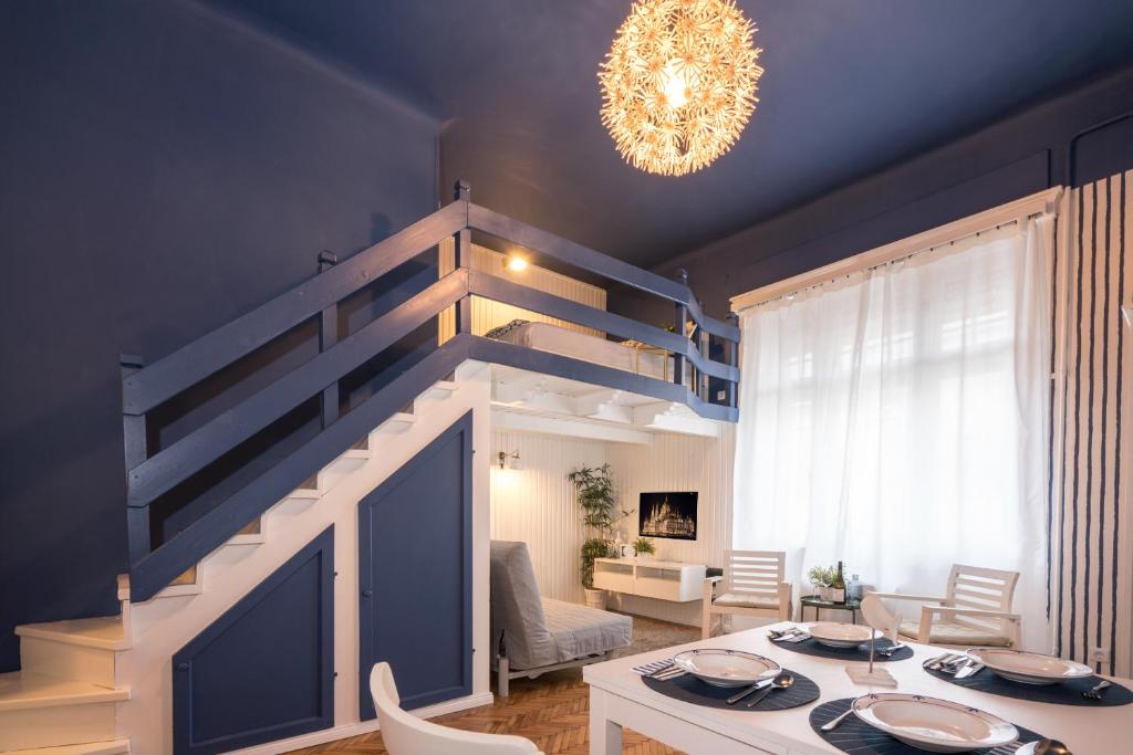 uma sala de estar com uma mesa e um lustre em Danube studio apartment em Budapeste