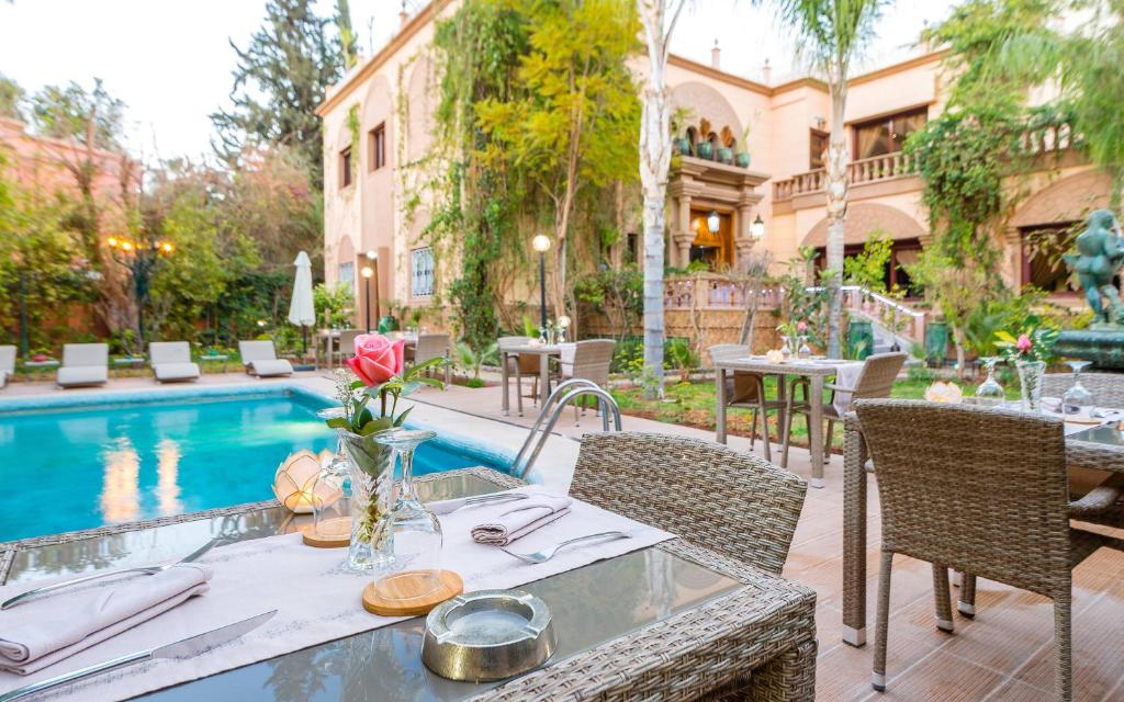 a dining room with tables and chairs in it at Hivernage Secret Suites & Garden in Marrakech