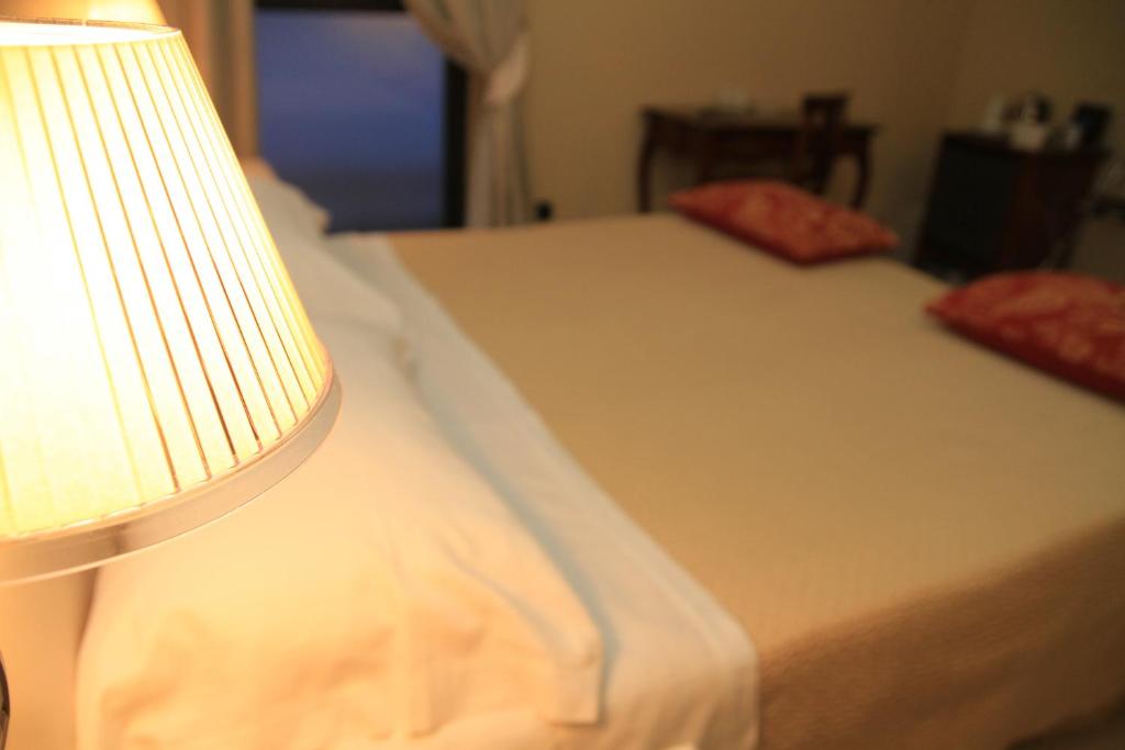 Postel nebo postele na pokoji v ubytování Albergo della Ceramica