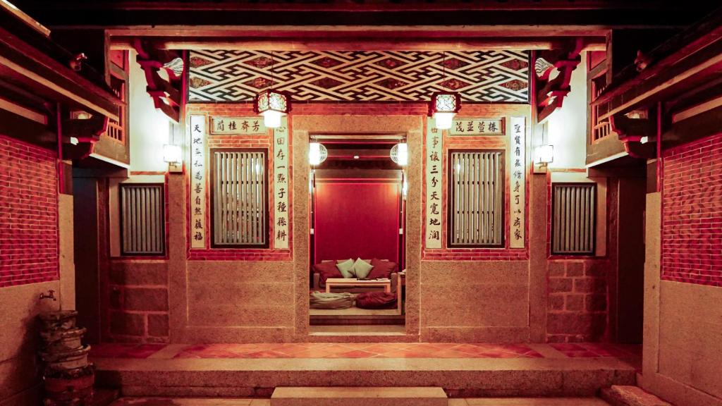 an entrance to a building with a red door at Beishan Old Western Style Hostel in Jinning