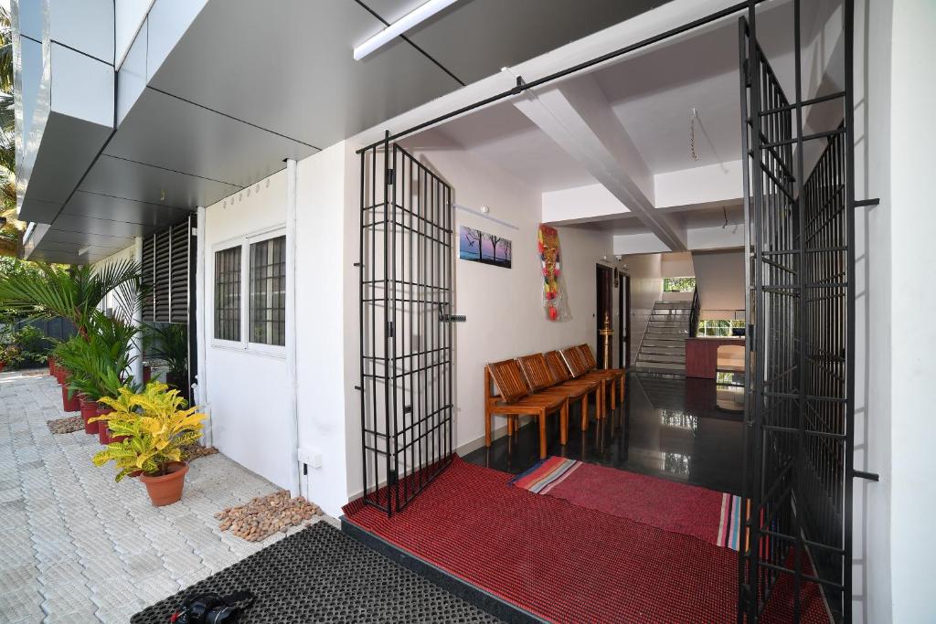 an open entrance to a house with a red rug at Indeevaram Residency in Trivandrum