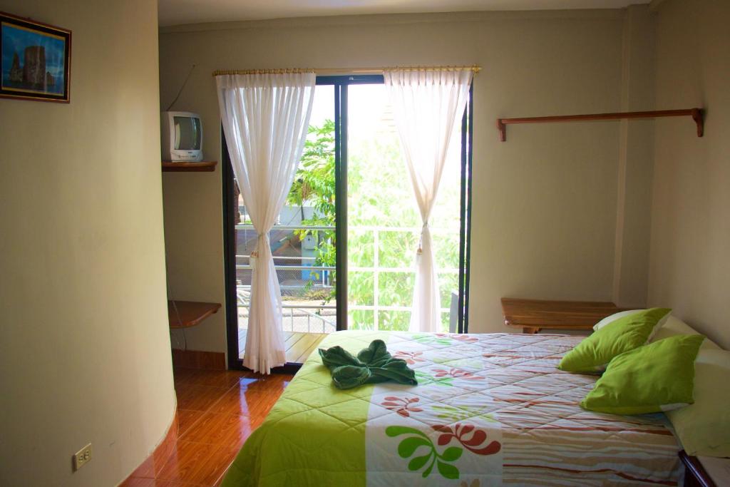 Postel nebo postele na pokoji v ubytování Hostal Nathaly