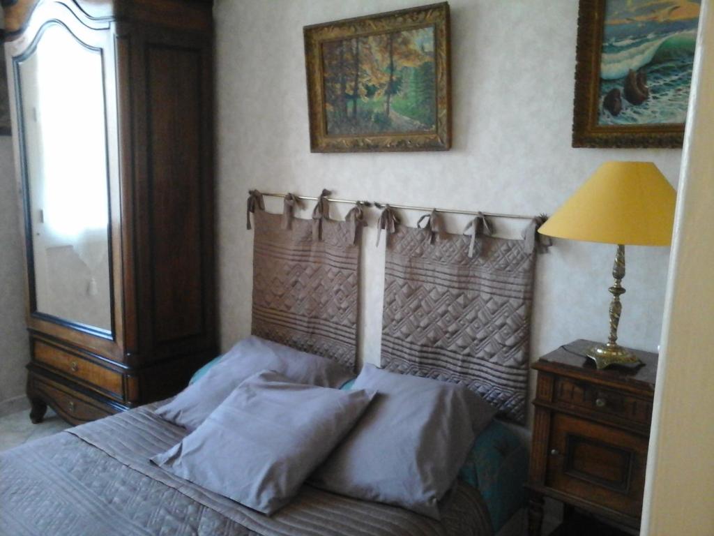a bed with a wooden headboard in a bedroom at Residence Privée in Nice