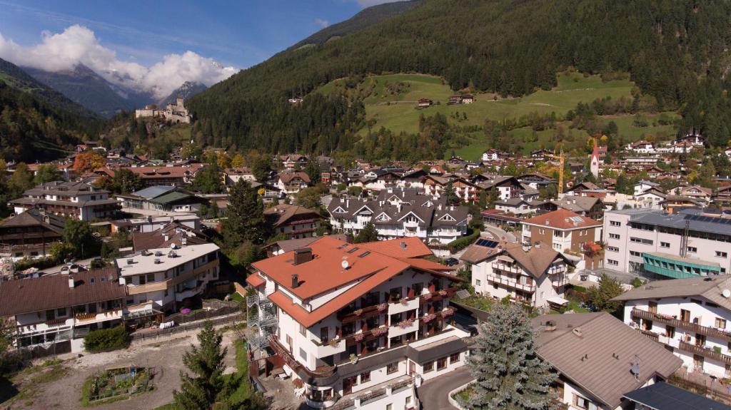 an aerial view of a town in the mountains at Hotel Hellweger in Campo Tures