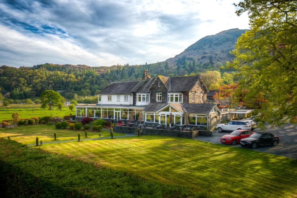 a large house with cars parked in front of it at The Grand at Grasmere in Grasmere