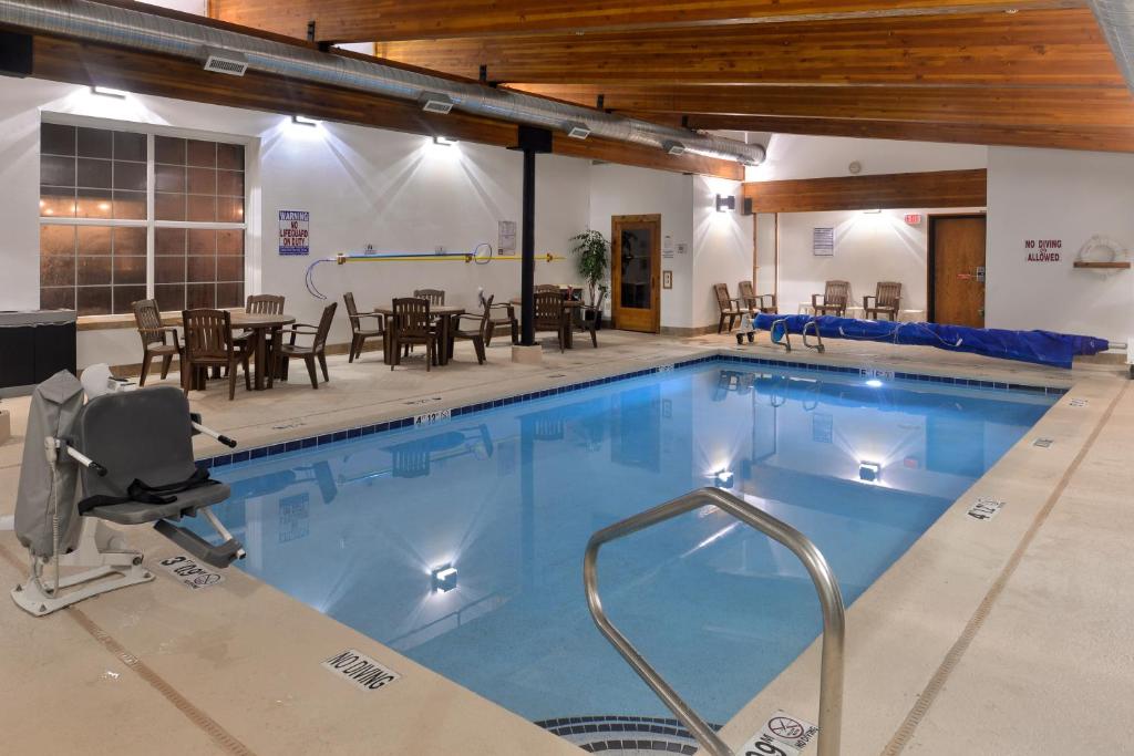 a large swimming pool with a table and chairs at Stage Coach Inn in West Yellowstone