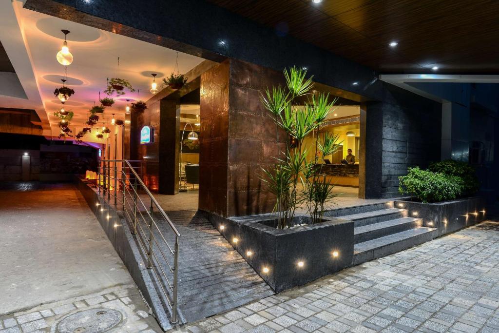 a lobby of a building with stairs and plants at Howard Johnson by Wyndham, Kolkata Airport in Kolkata