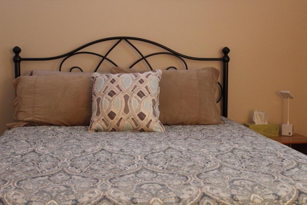 a bedroom with a bed with pillows and aintendent at Attractive East Hill Apartment in Ithaca