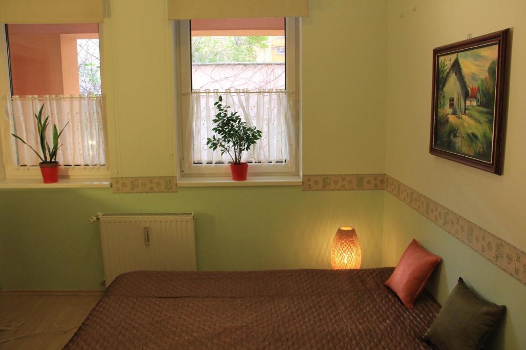 Posteľ alebo postele v izbe v ubytovaní Raday Central Apartment