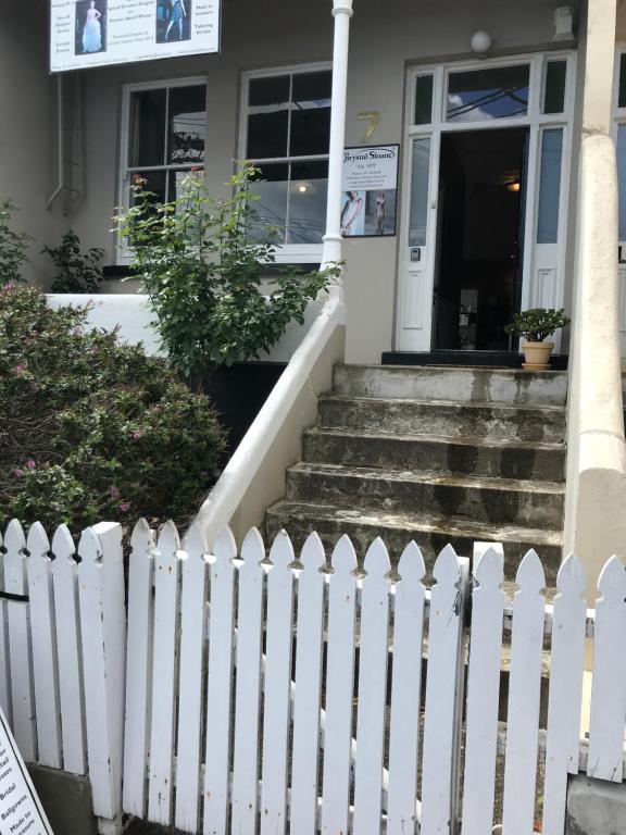a white picket fence in front of a house at Ponsonby Boutique Villa with Private Gym in Auckland