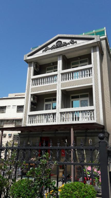 a tall building with a balcony on the side of it at Fengming B&amp;B in Jinning