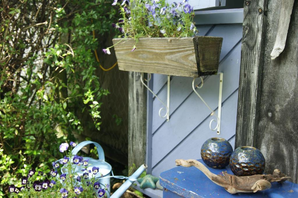 a wooden box with a planter and some flowers at Waitapu Springs B&B in Takaka