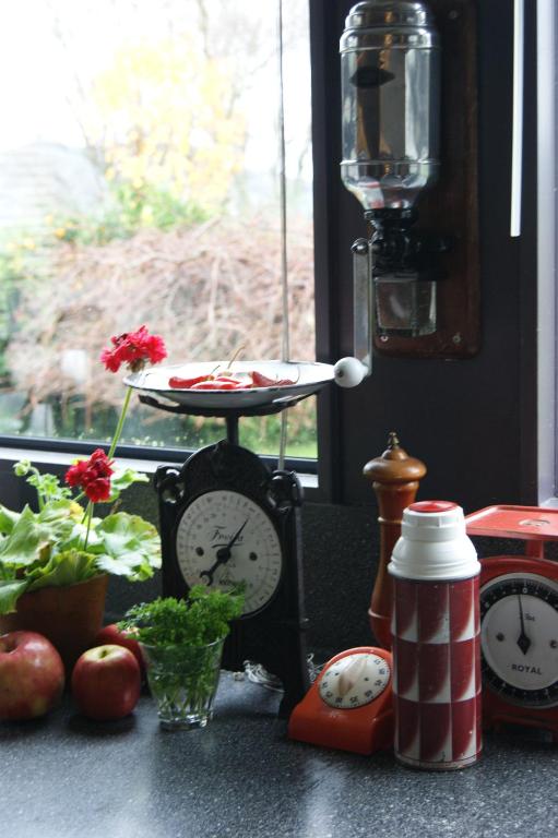 a counter with clocks and a table with food on it at Waitapu Springs B&B in Takaka