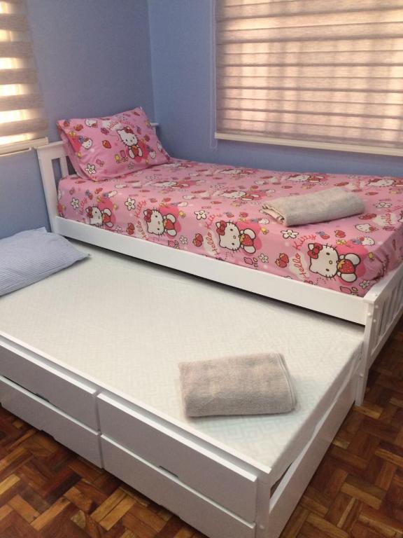 Postel nebo postele na pokoji v ubytování Hillary Timog Park Homes