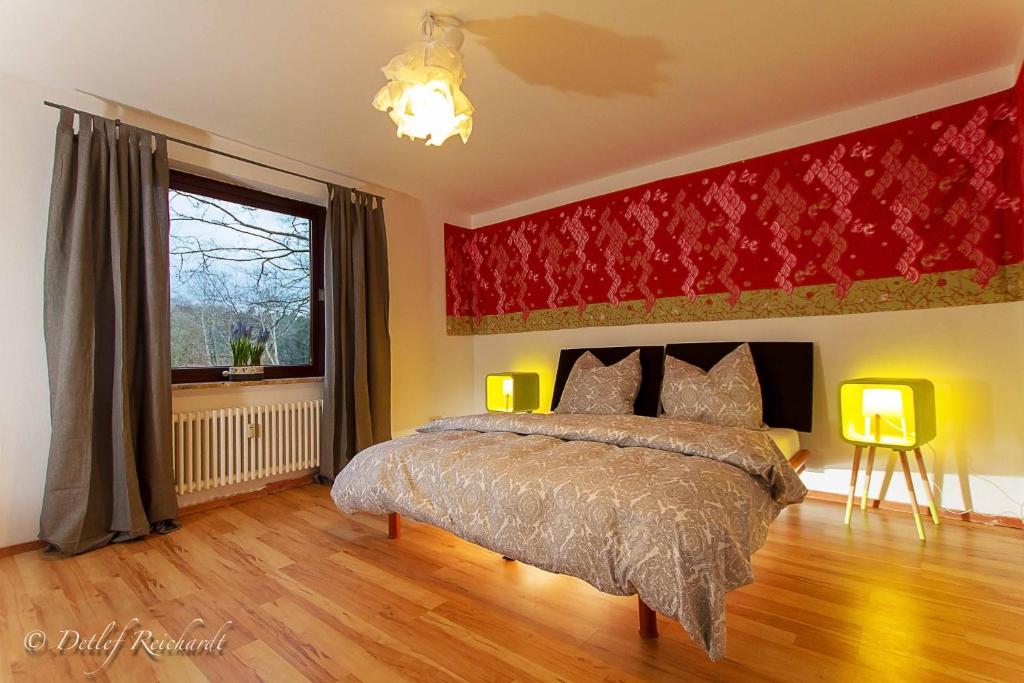 a bedroom with a large bed and a window at Villa im Reiterdorf in Beverstedt