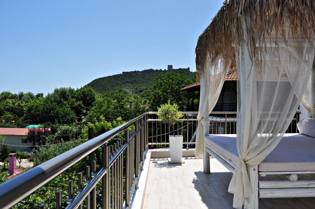 a hammock on the balcony of a house at Efrosini Hotel Apartments & Studios in Paralia Panteleimonos