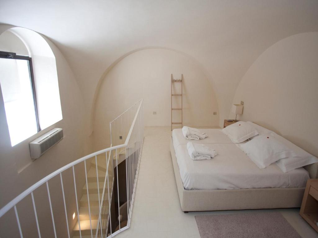 Кровать или кровати в номере La Sommità Relais & Chateaux