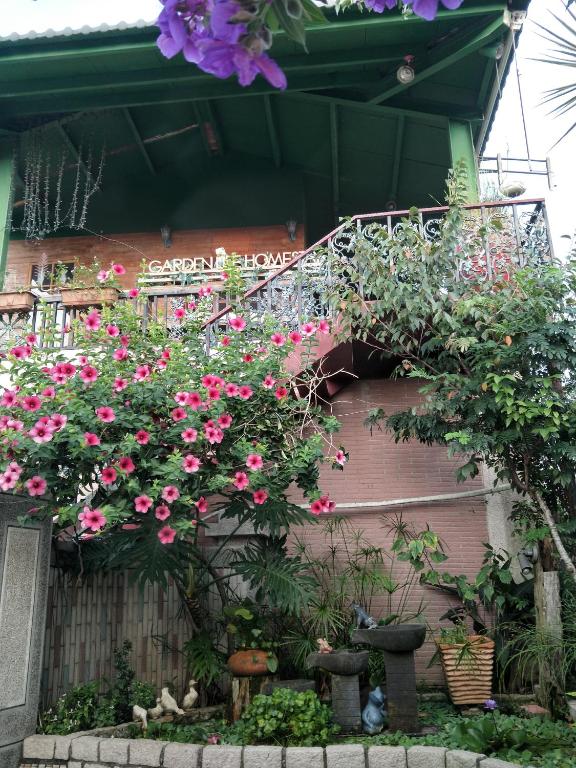 a bunch of flowers hanging from a building at Taichung Xinshe Garden Life Homestay B&amp;B in Xinshe