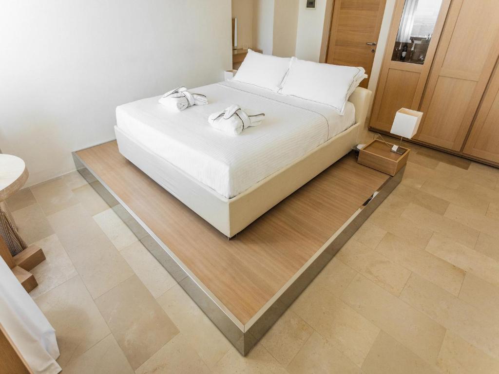 Кровать или кровати в номере La Sommità Relais & Chateaux